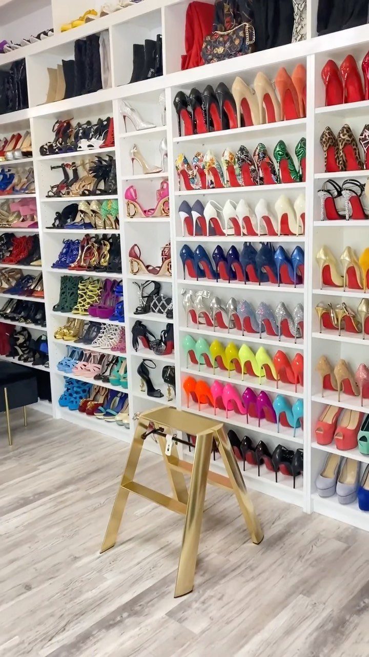 21 Closet Design Plans for Every Layout and Budget 21 White built-in shelving units filled with many colorful high-heeled shoes and clothing in a walk-in closet.