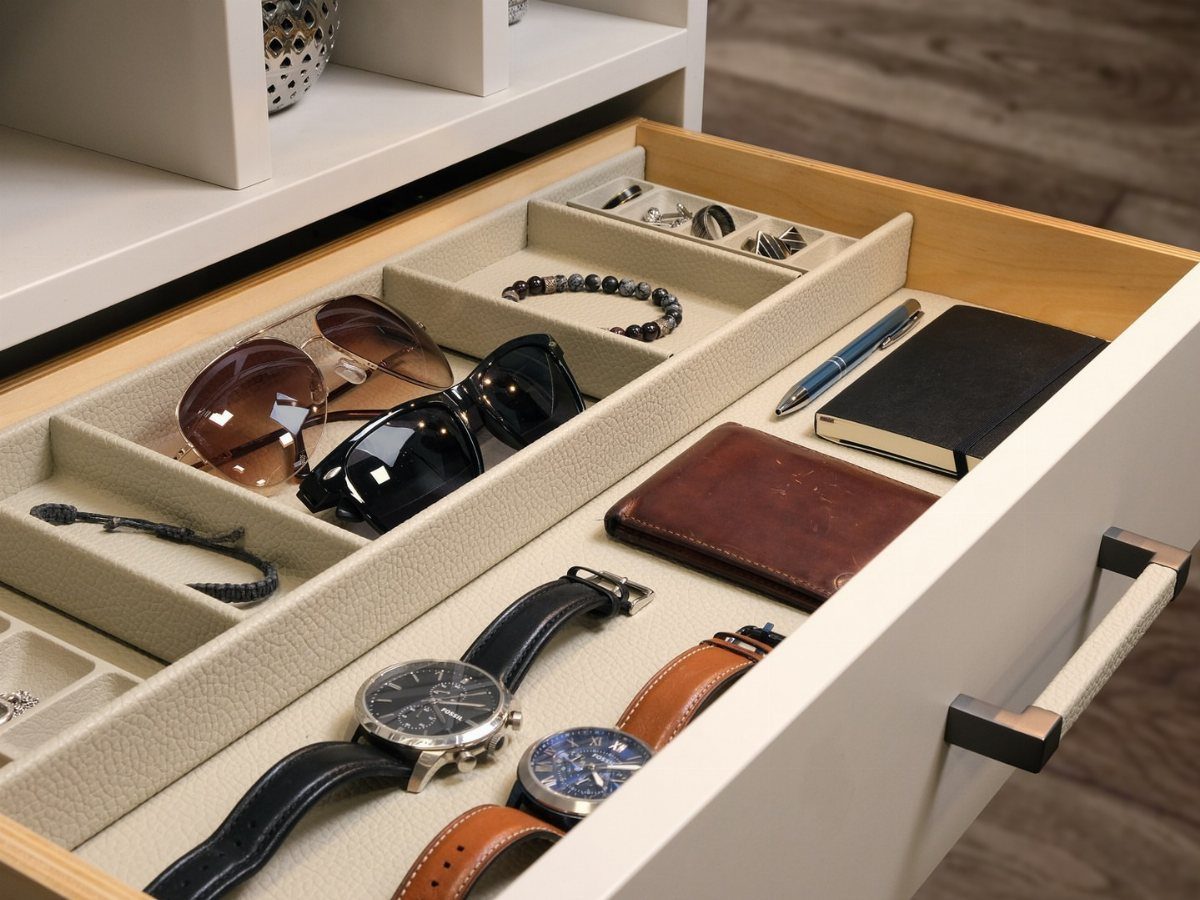 DIY Closet Organization: 16 Ideas for Every Layout 13 An open white drawer with beige dividers holding sunglasses, watches, a wallet, and a notebook.