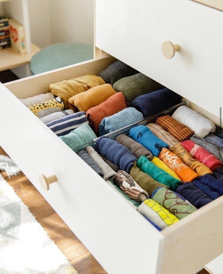 DIY Closet Organization: 16 Ideas for Every Layout 15 Neatly folded colorful clothing organized in rows inside an open white drawer.