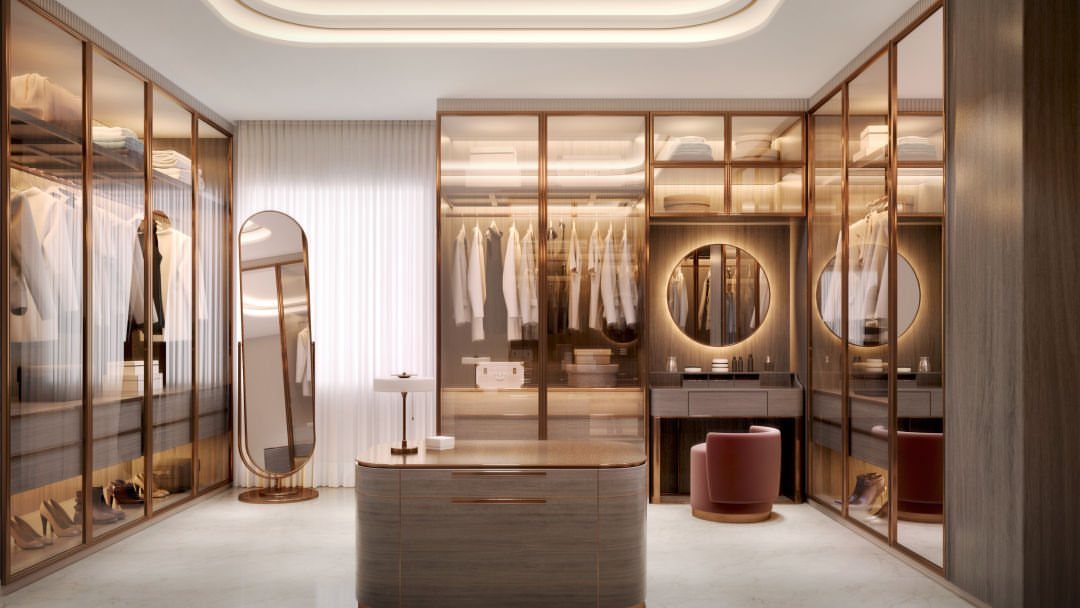 21 Closet Design Plans for Every Layout and Budget 11 A luxury walk-in closet with glass wardrobes, a central island, and a large oval mirror.