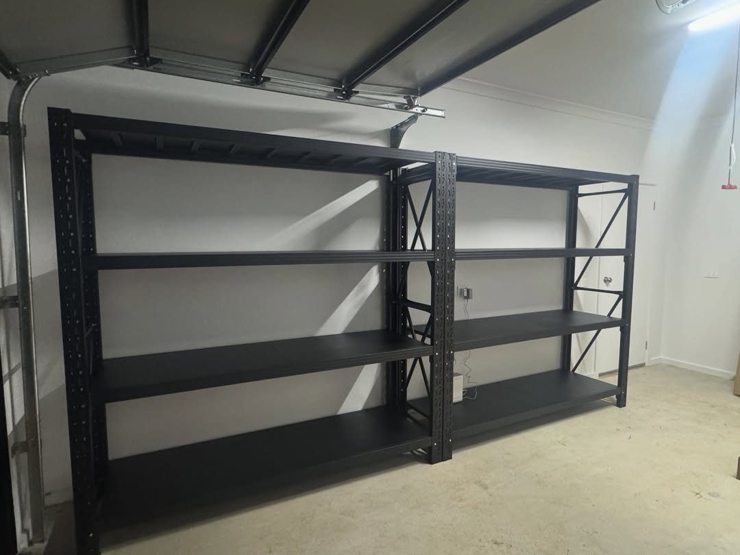 Garage Storage Modern: 12 Ideas That Free Up Floor Space 4 Two empty black metal industrial shelving units against a white garage wall.