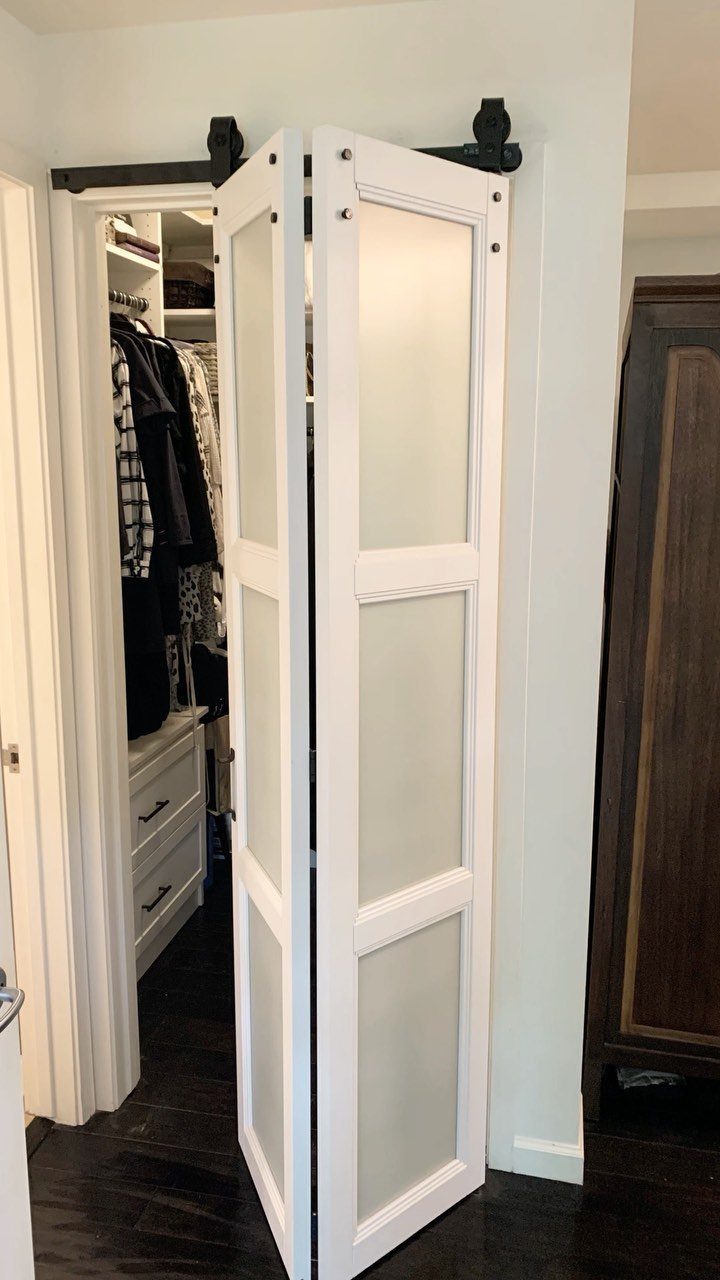DIY Closet Organization: 16 Ideas for Every Layout 8 White frosted glass sliding barn doors installed on a black metal track over a closet entrance.