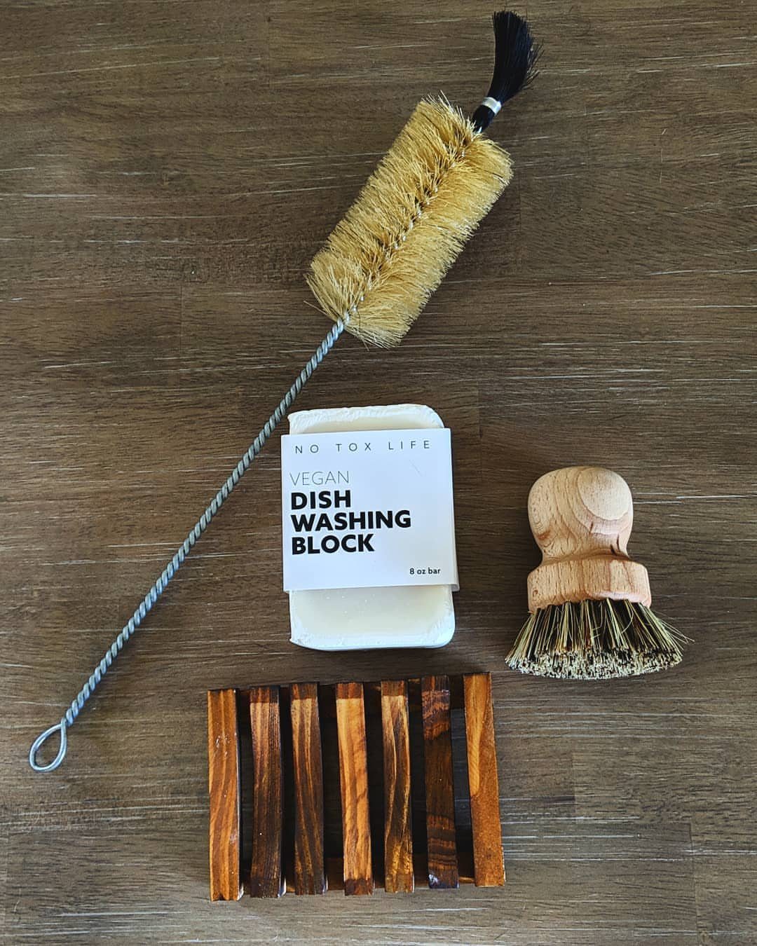 Non Toxic Kitchen Essentials: 10 Pieces That Actually Work 8 Natural bristle dish brushes, a soap block, and a wooden soap dish on wood.