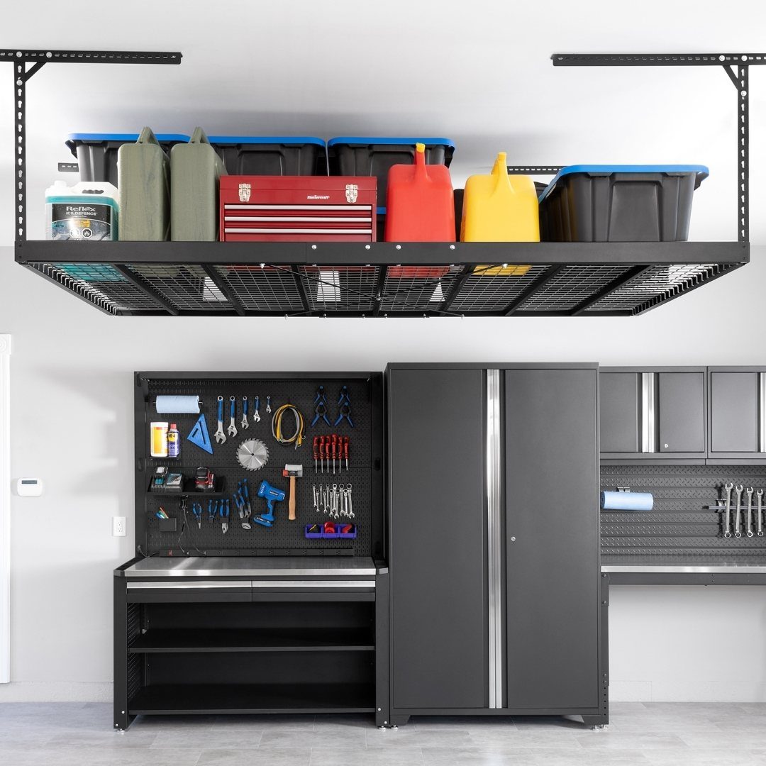 Black metal overhead storage rack holding blue bins and colorful containers in a garage setting.