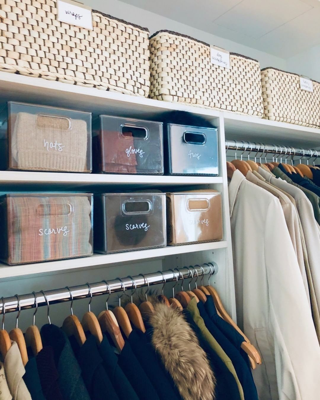 DIY Closet Organization: 16 Ideas for Every Layout 6 Clear plastic storage bins with handwritten labels sit on white shelves in an organized closet.