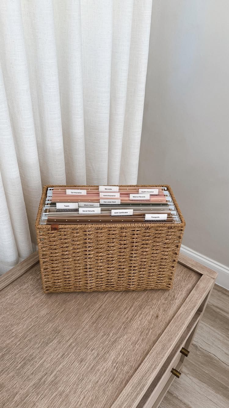 12 Office Storage Room Organization Ideas for Every Layout 10 A wicker basket filled with organized files and labeled folders sitting on a wooden dresser.